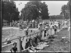 Children at a swimming pool with parents looking on, park in background, Hawke's Bay District
