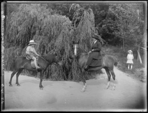 The children of A E Williams horse riding on the family property, 'Clariench', showing a young boy on a pony, a woman on a horse and a young girl in the background, Hawkes Bay