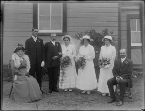 Wedding group, showing bridegroom, bride and wedding party, location unidentified