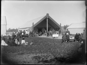 Hui at Omahu Marae, Fernhill, Hastings, showing a kaumatua holding a cane, standing in front of a table with trophies on it