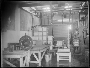 An interior view of the butter factory, Heretaunga Co-op Dairy Co Ltd, showing a load of butter on scales, a stack of butter packing boxes in the background, Heretaunga Plains, Hawkes Bay