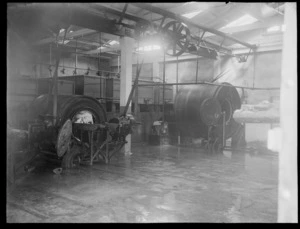 An interior view of the butter factory, showing processing machines with a load of butter on a tray and in one of the machines, Heretaunga Co-op Dairy Co Ltd, Heretaunga Plains, Hawkes Bay