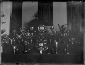 A display of swimming trophies on a stand in a hall, Hastings