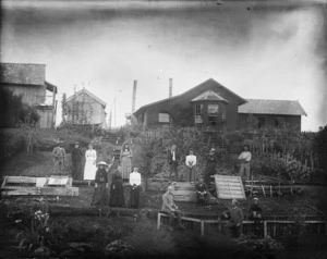 Bothamley, Arthur Thomas, 1846-1938 :Unidentified group alongside houses and gardens in the Taranaki Region