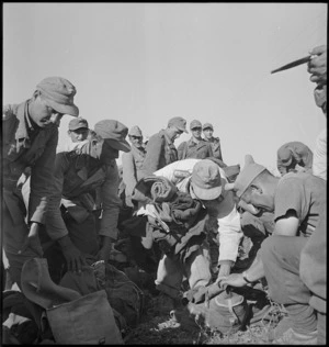 Axis POWs having their kits searched in Tunisia, World War II - Photograph taken by M D Elias