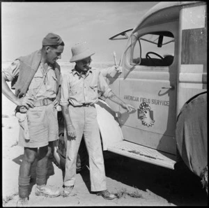 Charles Perkins of the American Field Service Unit points to his company's crest, Egypt - Photograph taken by H Paton
