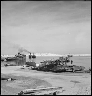 Scene at Mersa Matruh Harbour with wrecked flying boat in foreground, Egypt - Photograph taken by M D Elias