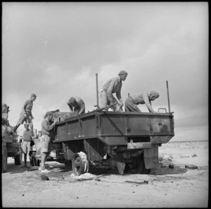 Party of NZers examining a knocked out enemy truck at Bardia, Libya - Photograph taken by H Paton