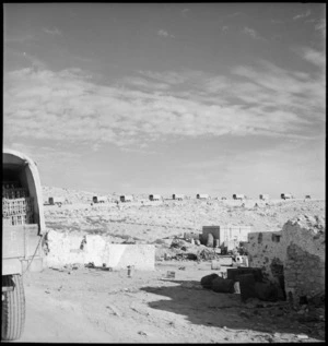 NZ supply column passing the wrecked Sollum barracks, Egypt - Photograph taken by M D Elias