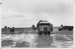 NZ convoy bogged down in flooded desert conditions at Fuka, Egypt, World War II - Photograph taken by Captain J White