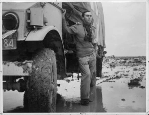 Captain G H Levein beside his medical truck in flooded desert conditions at Sidi Haneish, Egypt, World War II - Photograph taken by G H Levien