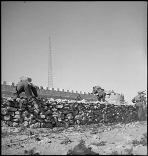 Infantry advancing over stone walls around fort at Cyrenaica, Libya - Photograph taken by M D Elias