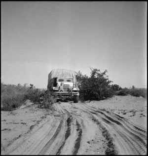 A NZ truck passes through typical open country in the Azizia region, Libya - Photograph taken by H Paton