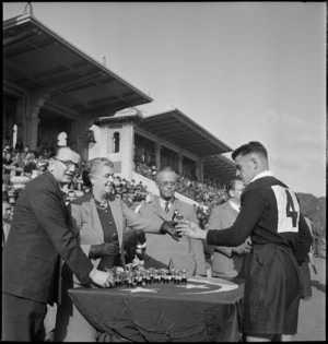 NZ player McHugh receives a trophy from Lady Wells after the NZEF v Rest of Egypt rugby match at Alexandria, Egypt - Photograph taken by M D Elias