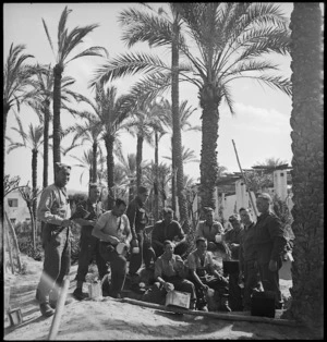 Meal time for NZ Infantry unloading supplies at Tripoli, World War II - Photograph taken by H Paton