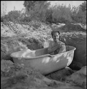 O C Cossey takes an open air bath near Tripoli, World War II - Photograph taken by H Paton