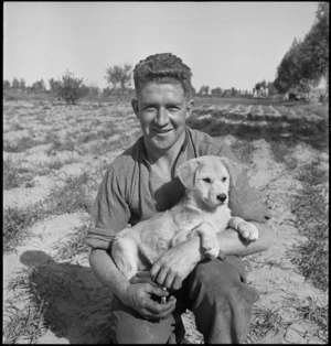 G J Lewis with Trip Trip, the unit pet in Tripolitania, Libya - Photograph taken by H Paton