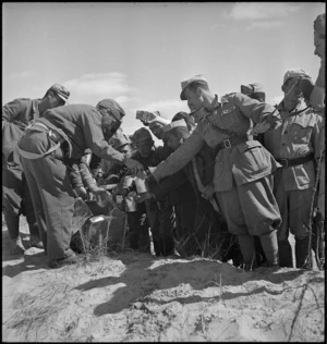 Prisoners of war being issued with water, Tunisia - Photograph taken by H Paton