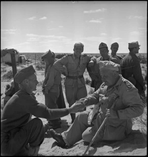 Elderly Italian padre captured in Tunisia receives ration of water - Photograph taken by H Paton