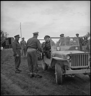 Russian Major General Vasiliev in his jeep shaking hands with Major General Freyberg as he leaves NZ Division, Italy - Photograph taken by G Kaye