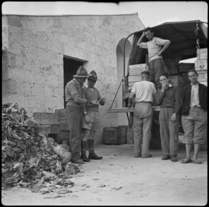 Sergeant Majors O'Brien and Young checking rations for refugees at Bari Camp, Italy - Photograph taken by W A Brodie