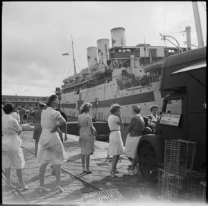 Red Cross workers with mobile canteen on the wharf at Alexandria as repatriated POWs come ashore from the hospital ship Tairea - Photograph taken by George Robert Bull