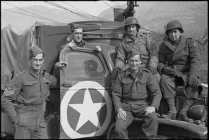 Group of American and New Zealand soldiers by truck with a white star at 5th Army front in southern Italy - Photograph taken by G Kaye