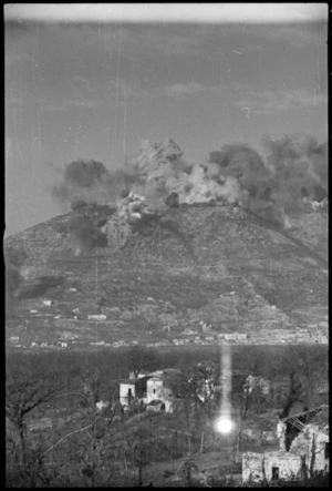 Ruins of Cassino with smoke obscuring Benedictine Monastery in the distance - Photograph taken by George Kaye