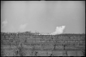 Photograph taken from Maori Battalion's forward defended locality showing shells bursting on enemy positions, Italy, World War II - Photograph taken by J Short