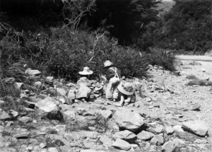 Four children playing on rocky ground