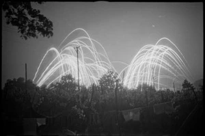 Typical night scene in NZ Division area near Trieste as flares celebrate news of cessation of war with Germany - Photograph taken by George Kaye