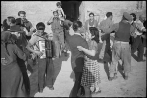 Italian civilians dancing in the streets in celebratin of their liberation by NZ troops in World War II - Photograph taken by George Kaye