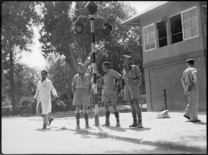 Three New Zealanders waiting a lift to Cairo on the Maadi Crossing, Egypt, World War II - Photograph taken by G Kaye