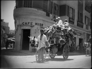 Street scene in Cairo showing local men and cart - Photograph taken by George Kaye