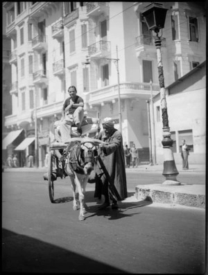 Street scene in Cairo showing local men and cart - Photograph taken by George Kaye