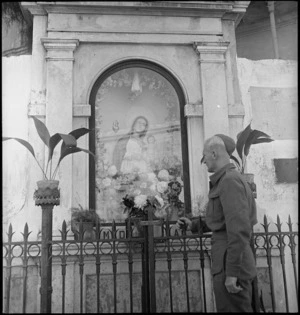 R Pennell shows interest in a wayside shrine in Bari, Italy, World War II - Photograph taken by George Kaye