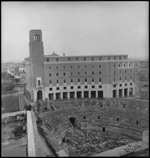 Roman amphitheatre and a modern building in the Italian town of Lecce, World War II - Photograph taken by George Kaye