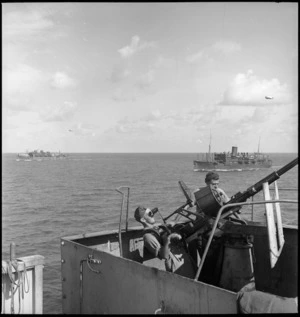 Gun crew at anti aircraft stations on transport carrying members of 2 NZ Division to Italy, World War II - Photograph taken by M D Elias
