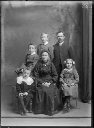 Studio portrait of members of an unidentified family, showing the man dressed in a Salvation Army tunic, with the S symbol on the collar, a woman and four children, possibly Christchurch district