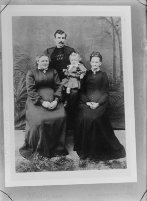 Studio portrait of unidentified two women, a man from the Salvation Army and a small child, probably Christchurch district - Photograph taken by Adam Maclay