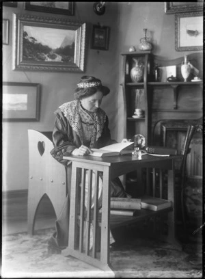Woman seated at a table reading