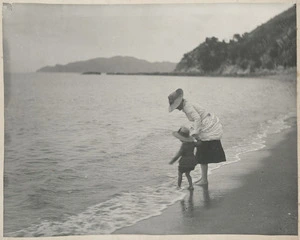 Edith Emily Fell with her daughter Sylvia paddling at the edge of the sea