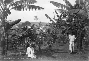 Native village near Suva, Fiji. Wife of chief on right