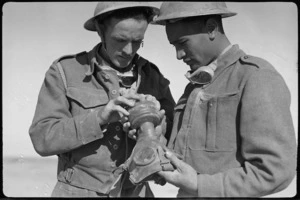 New Zealanders examine captured German gas mask, World War II