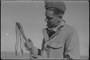 NZ soldier examines a captured whip during 2nd Libyan Campaign