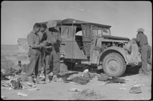 New Zealanders examine abandoned German staff car, World War II