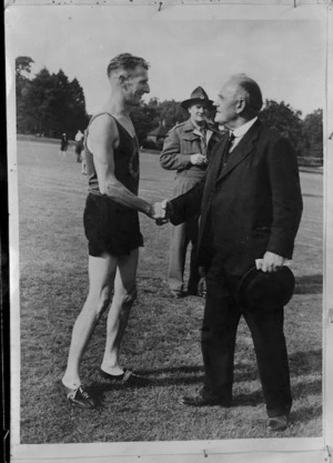New Zealand High Commissioner William Joseph Jordan congratulates E J Johnson on winning the mile at NZ Forestry Company sports, World War II