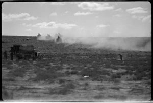 Armed columns stir up dust advancing with the NZ Division into Libya, World War II