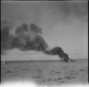 Trucks burning following air attack during the advance into Libya, World War II