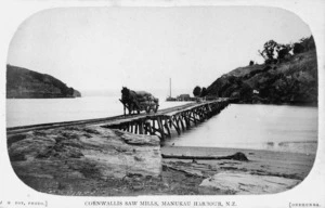 Horse and cart on a bridge over Manukau Harbour, alongside Cornwallis sawmills